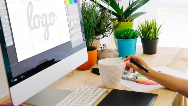 desk with computer and pen tablet logo design